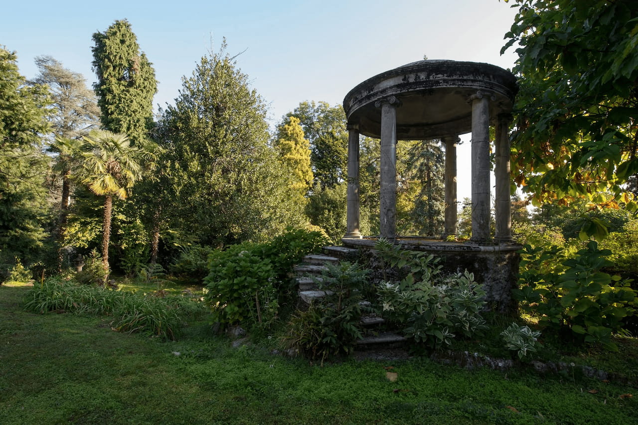 The romanic garden gazebo surrounded by mature trees
